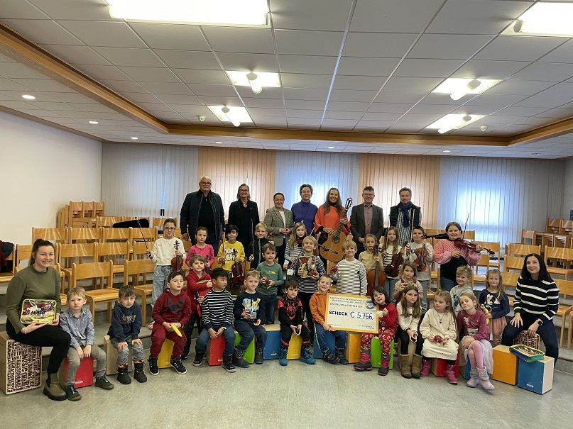 Bernd Sengseis (F&ouml;rderverein Musikschule), Monika P&uuml;lz, Andrea Volpini de Maestri, B&auml;rbel Humitsch und Julia Malischnig, Musikschulleiter Hans Brunner und Leiter der VS West, Florian Zm&ouml;lnig, mit den musizierenden Kindern und P&auml;dagoginnen. Foto: Kari/Soro